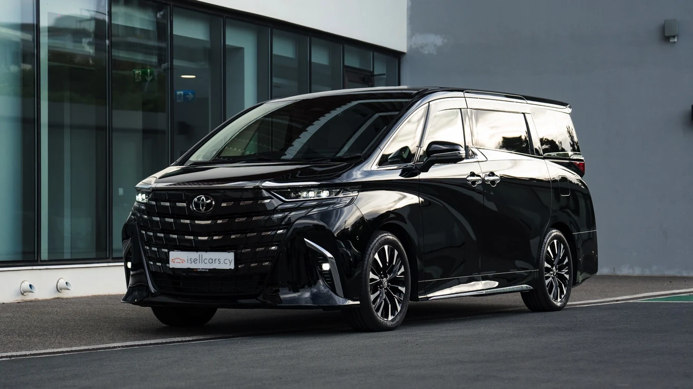 Black 2025 Toyota Alphard Executive Lounge in Cyprus, front three-quarter view outside the showroom. Car 97